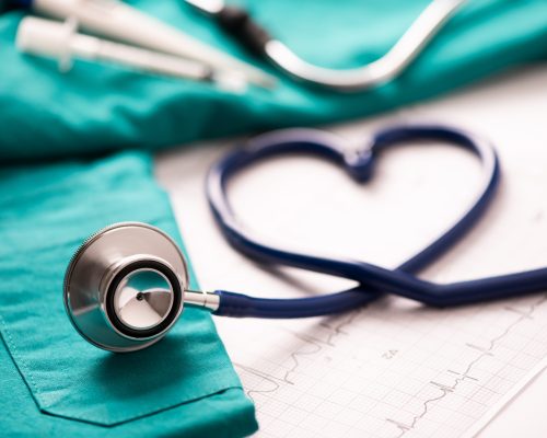 Medical stethoscope twisted in heart shape. Close up